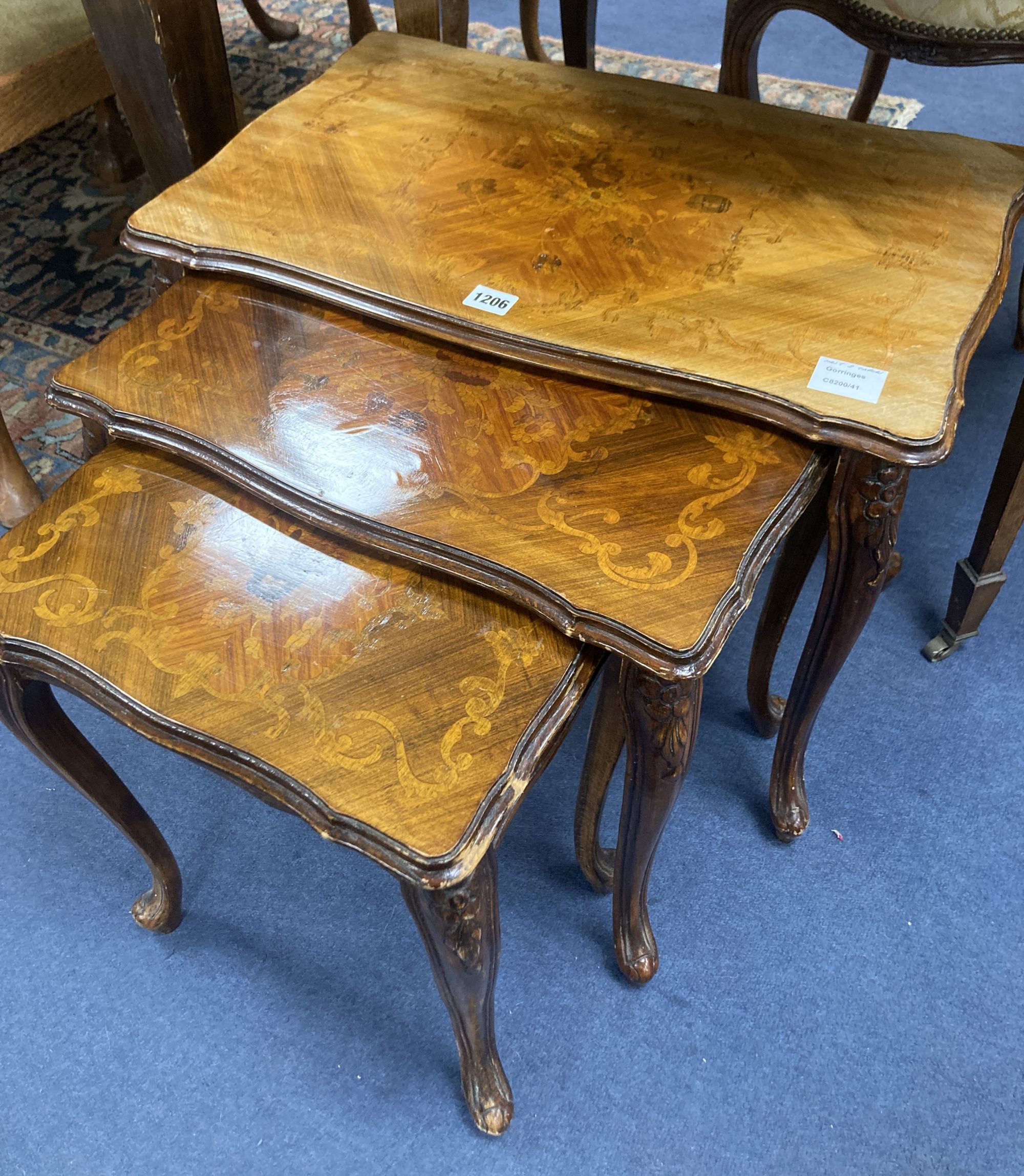 A nest of three marquetry inlaid walnut tea tables, width 59cm, depth 36cm, height 49cm